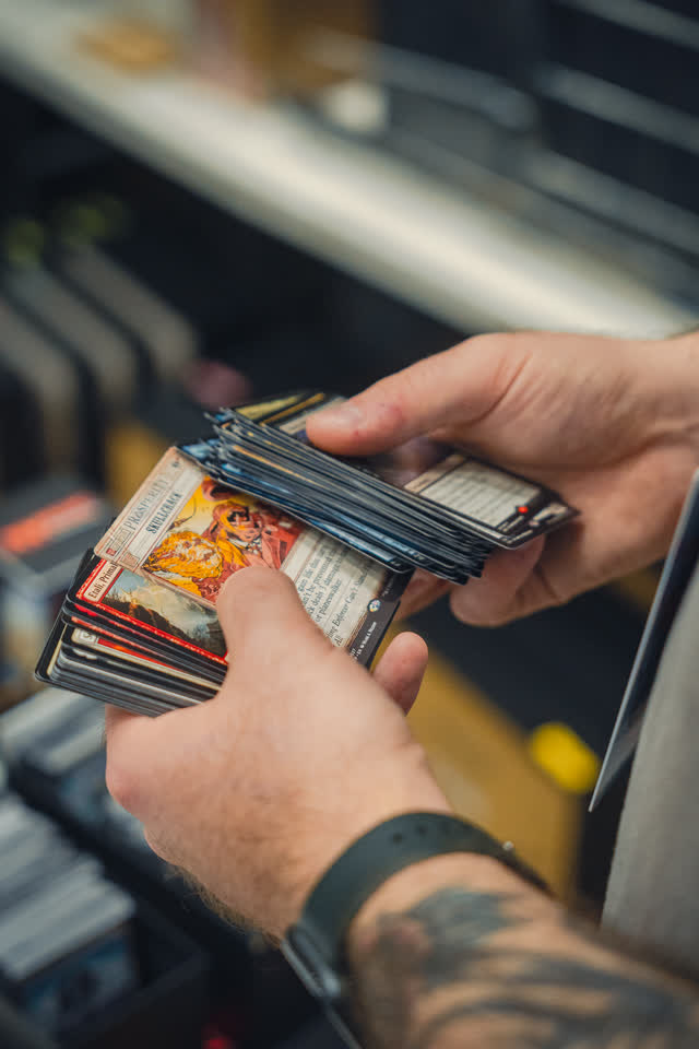 Close on a pair of hands flicking through a rack of graded slabs.