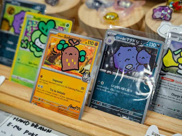 Hand-drawn custom cards displayed on a maker stand.