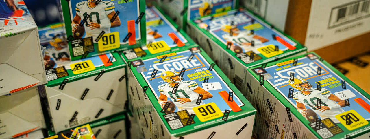 Boxes of Score American football cards stacked up on a stand.