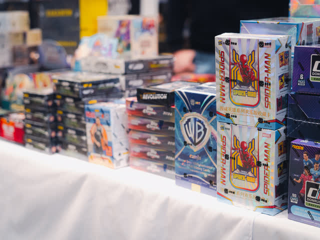 Sealed boxes of Marvel, Donruss and other trading card product stacked on a white table.