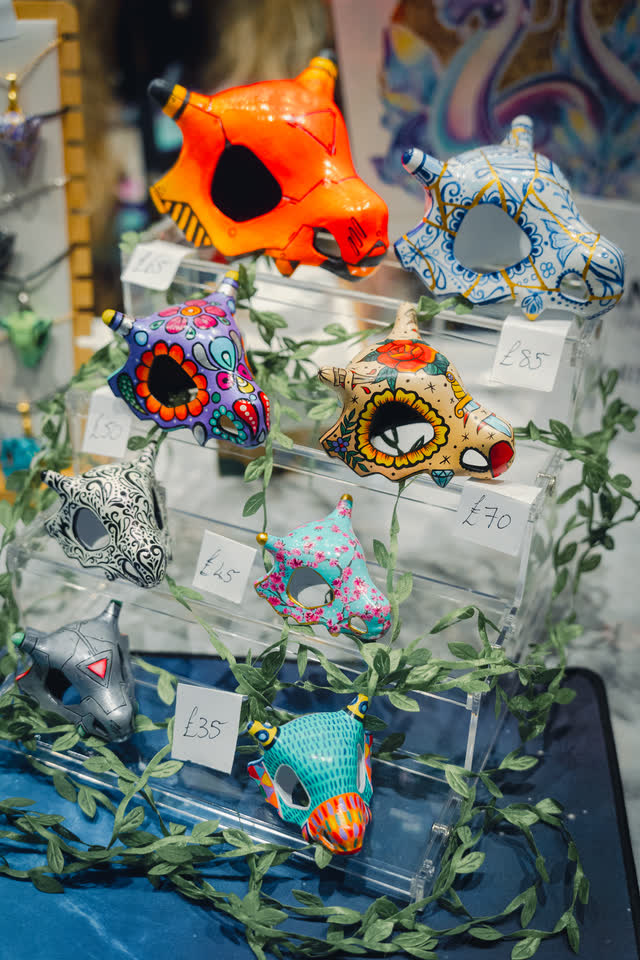 Hand-painted decorative skulls on acrylic shelves with price tags.