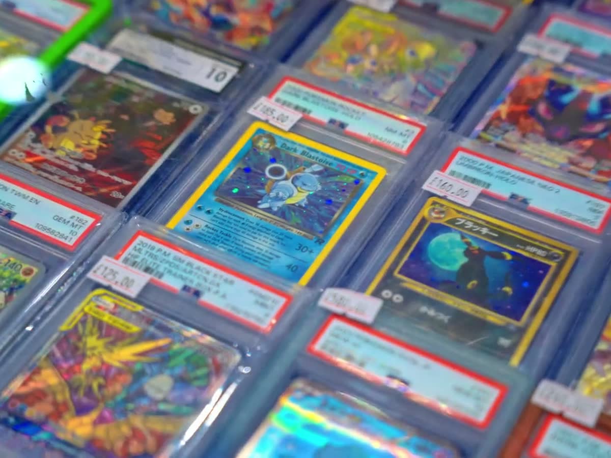 Graded vintage cards in red-labelled slabs laid out across a table.